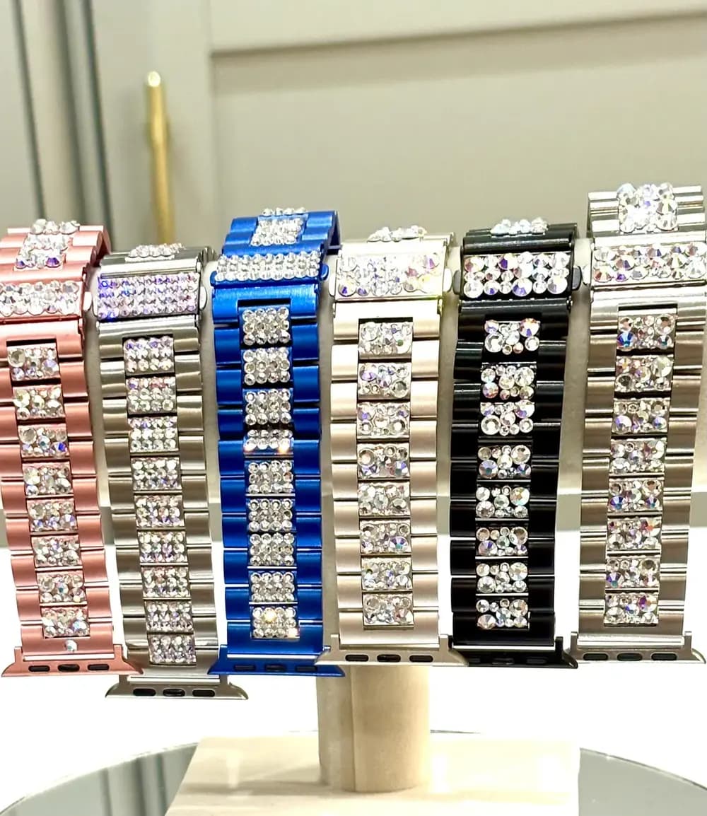 Swarovski Crystal Smart Watch Bracelet in various colors on display, showcasing sparkling crystals on stainless steel straps.
