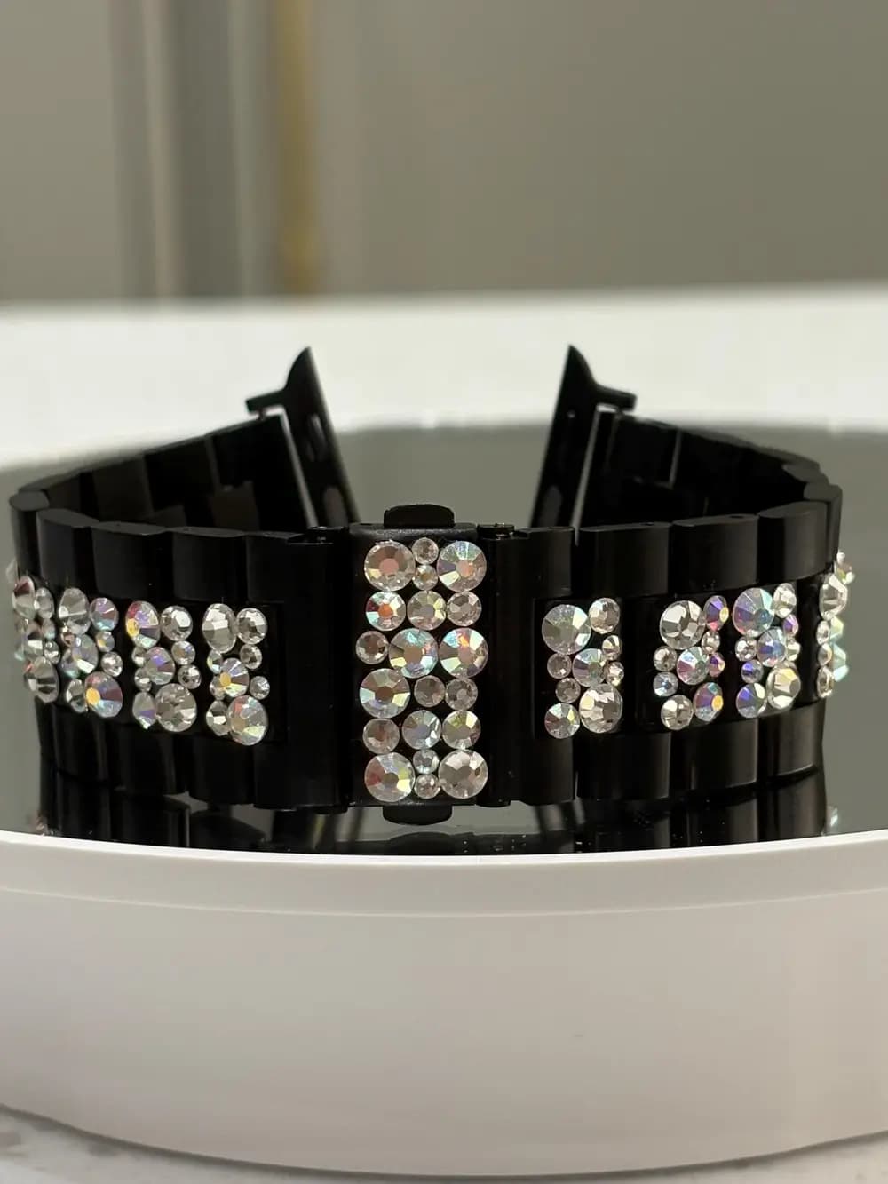 Swarovski Crystal Smart Watch Bracelet with sparkling crystals on a black stainless steel strap, displayed at an angle.