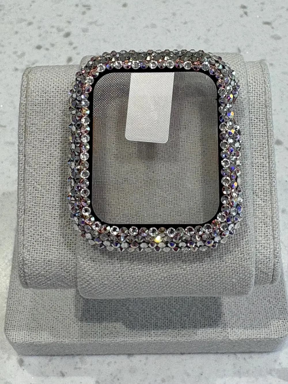 Luxury Watch Screen Case with Preciosa® Crystals, displayed on a gray fabric stand, showcasing sparkling crystal embellishments.