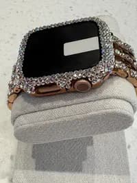 Luxury Watch Screen Case with Preciosa® Crystals, surrounded by sparkling crystals, displayed at an angle on a cushioned stand.