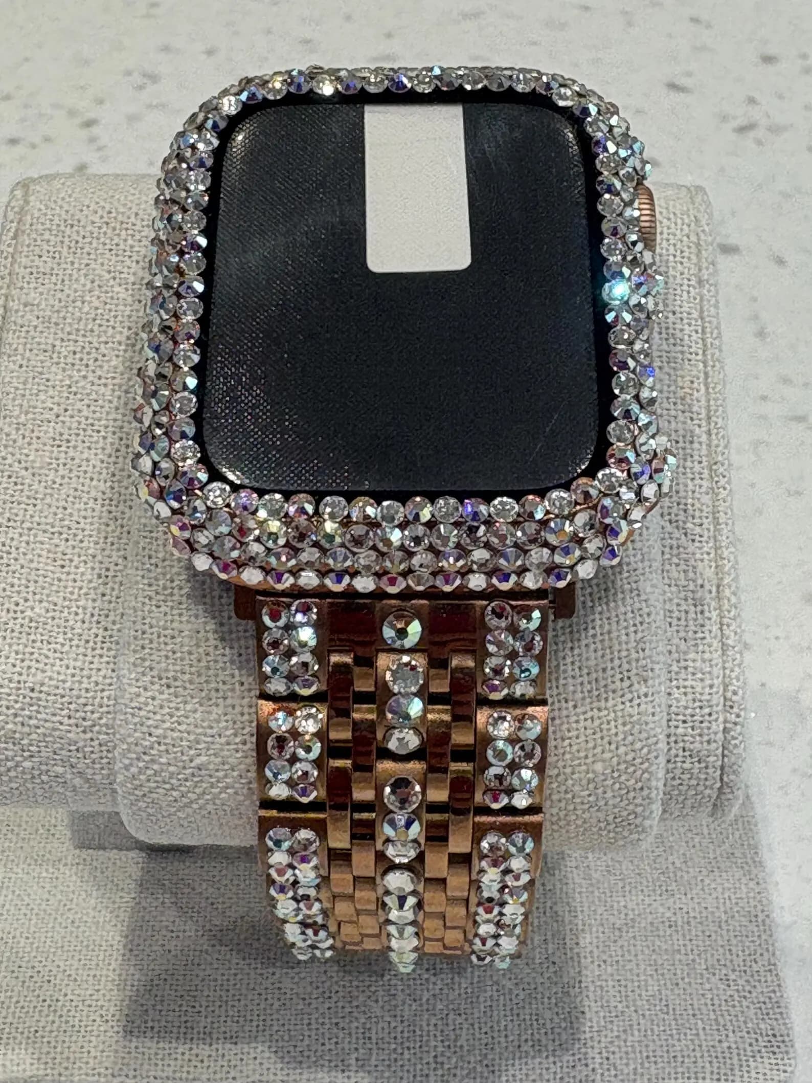 Luxury Watch Screen Case with Preciosa® Crystals, featuring a rose gold band and crystal-covered bezel, displayed on a cushion.
