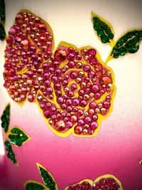 Sparkling Crystal Flower Mug; close-up of pink and green crystal floral design on a ceramic surface with a gradient pink background.
