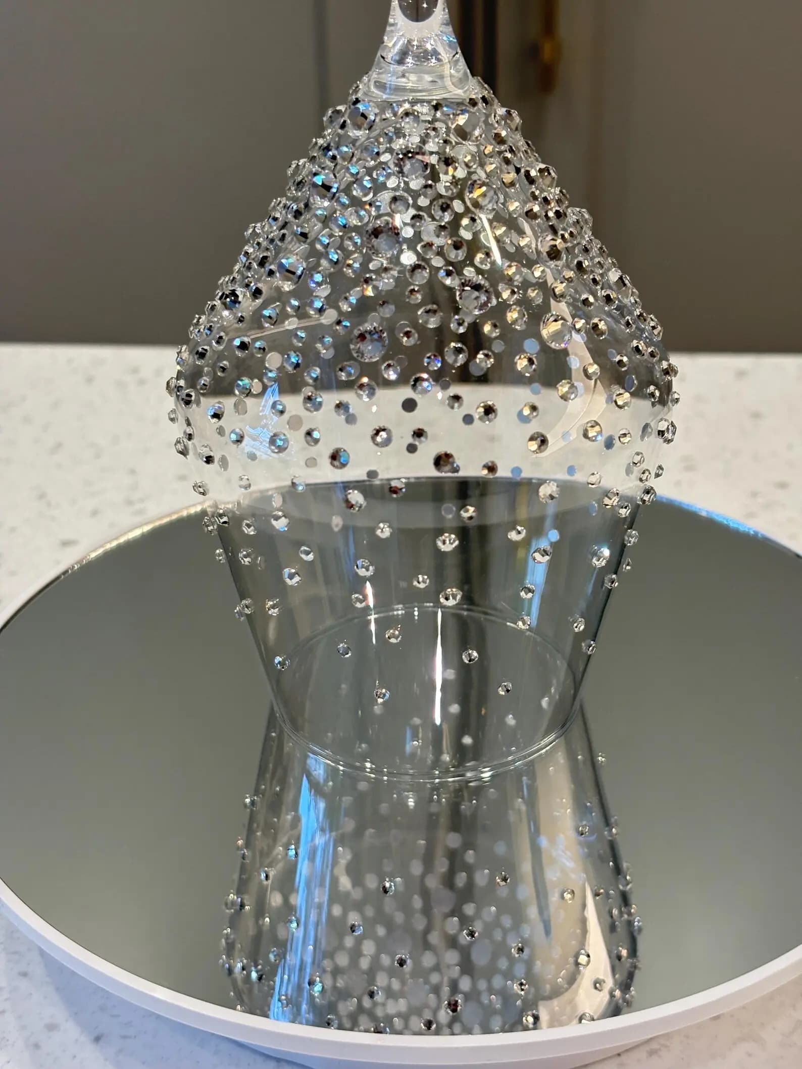 Luxury Crystal White Wine Glass with sparkling crystals, inverted on a mirror, highlighting its elegant, decorative design.