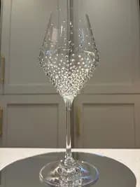 Luxury Crystal White Wine Glass, decorated with sparkling crystals in a graduated design, displayed on a reflective surface.